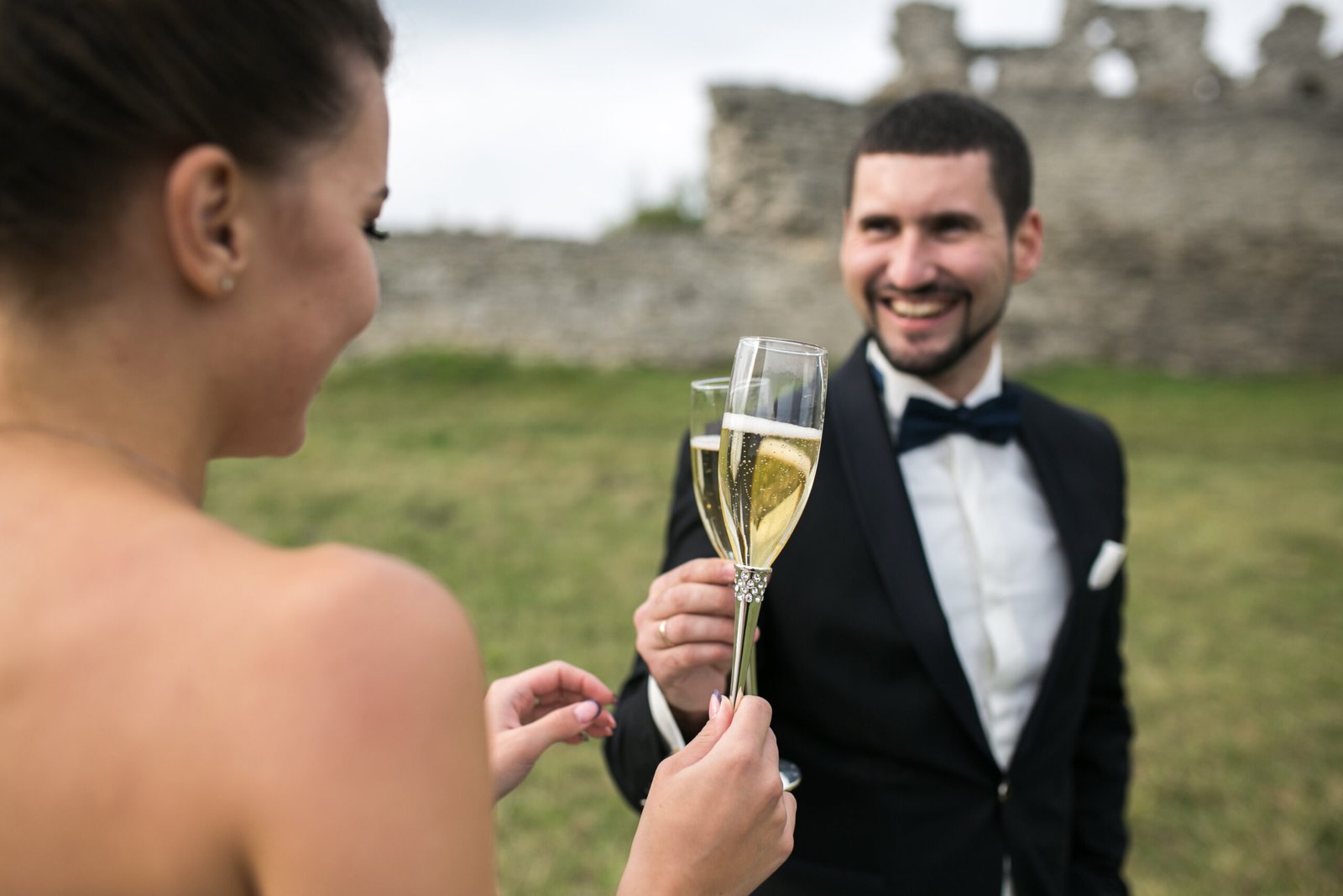 bridal couple clink glasses of champagne on the nature